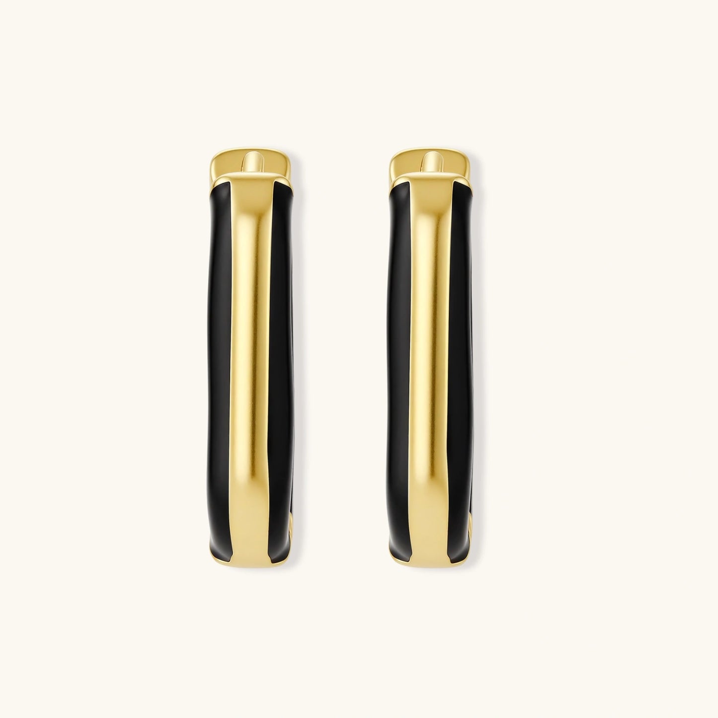 Modern hoop earrings with gold-plated and black sections, featuring hinged closure on white background.
