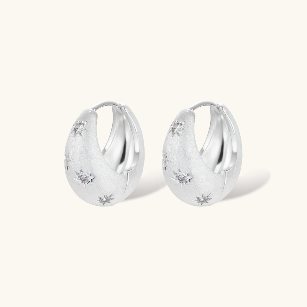 Silver-plated hoop earrings with star cutout designs, shown open and closed on white background, 17mm diameter.