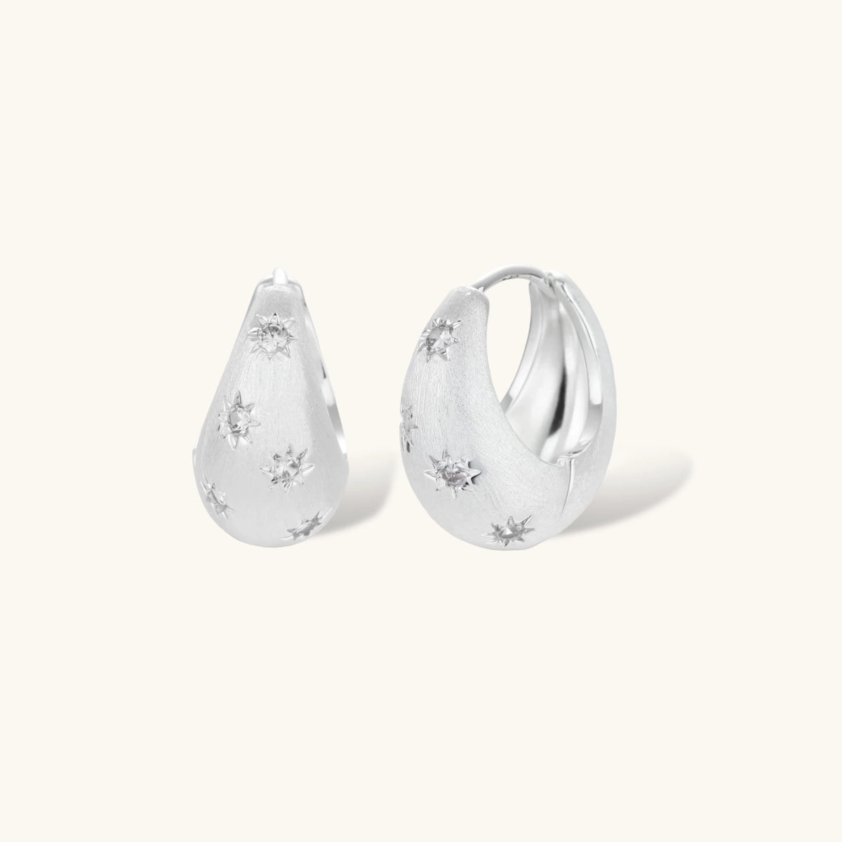 Silver-plated hoop earrings with star cutout designs, shown open and closed on white background, 17mm diameter.